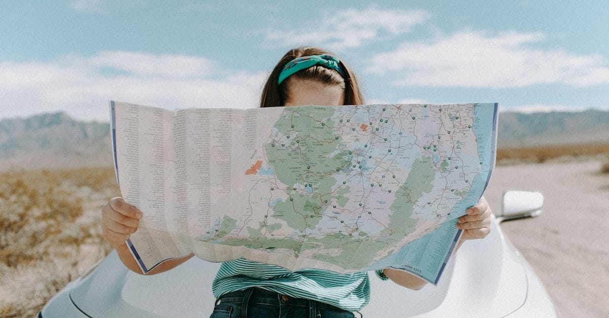 woman traveling looking at map writer for well paying magazine