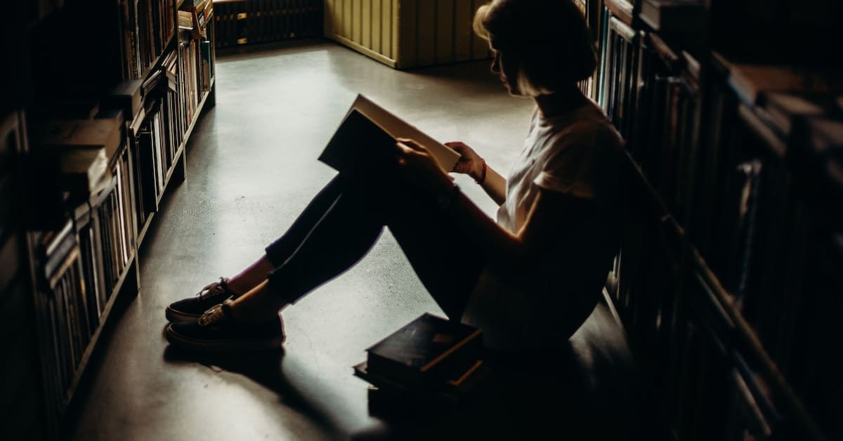 woman reading a best selling book in a library