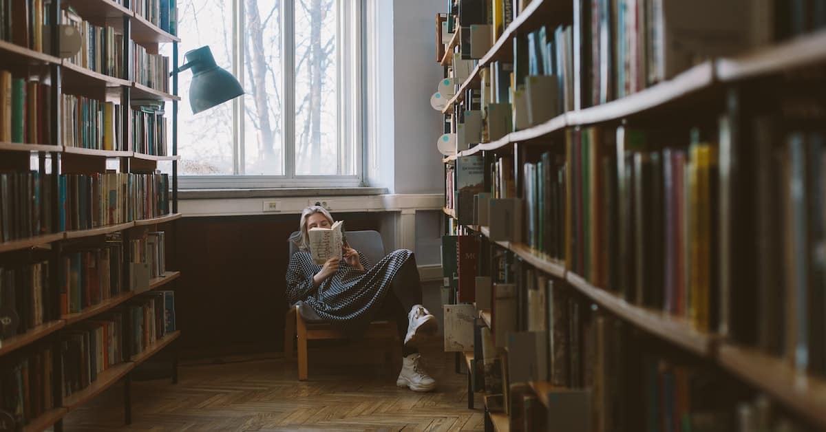 woman reading in book store to get motivated to write