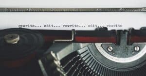 typewriter with edit and rewrite typed on page