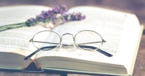 book with glasses and flower written with an outline